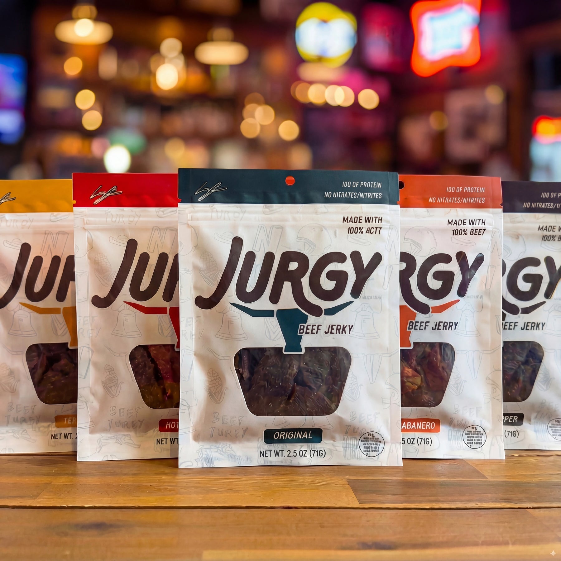 Product image prompt: Round Robin Jurgy Sampler displayed as multiple jerky pouches or packs arranged in a clean grid on a neutral rustic surface; a few jerky pieces visible to show texture and marbling; premium ranch-to-pouch aesthetic, minimal props, diffused flattering light, film-inspired low contrast, ultra-realistic editorial product photography.